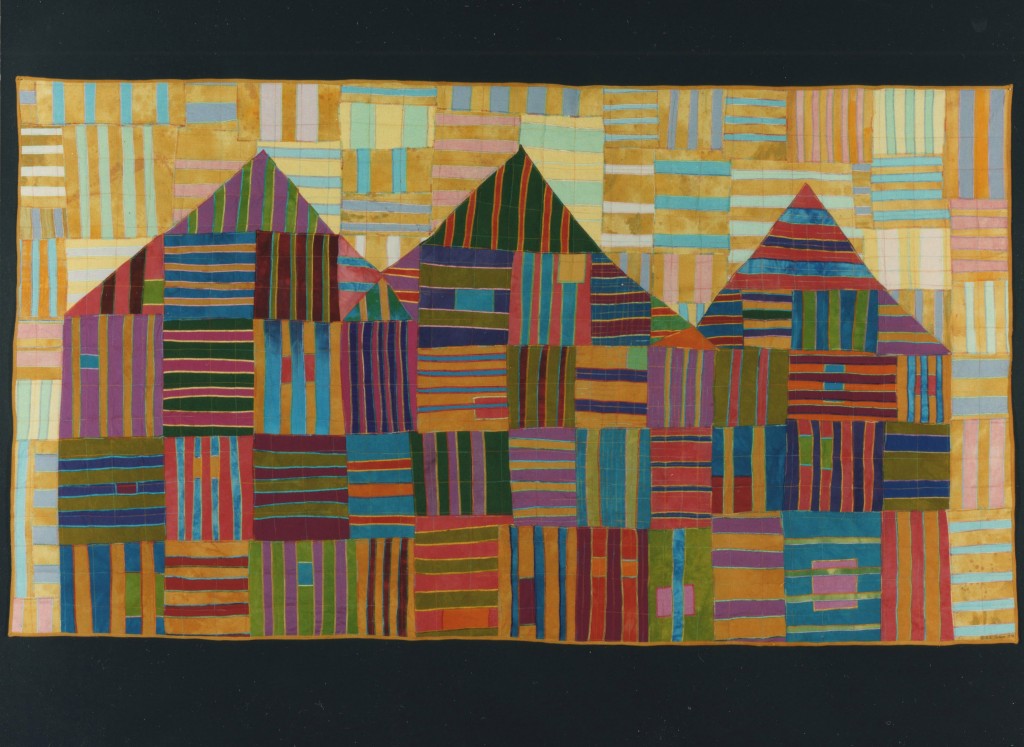 A textile art with three houses